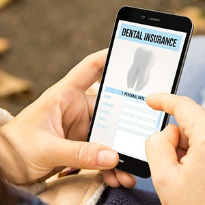 Looking at dental insurance form on smartphone