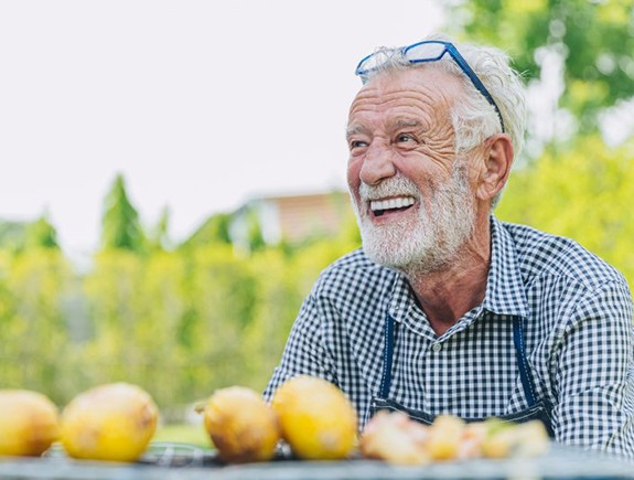 Man smiles outdoors