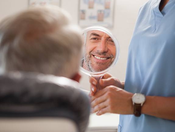 A middle-aged man happy with the results of his root canal